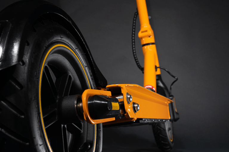 low close up of electric scooter rear wheel orange