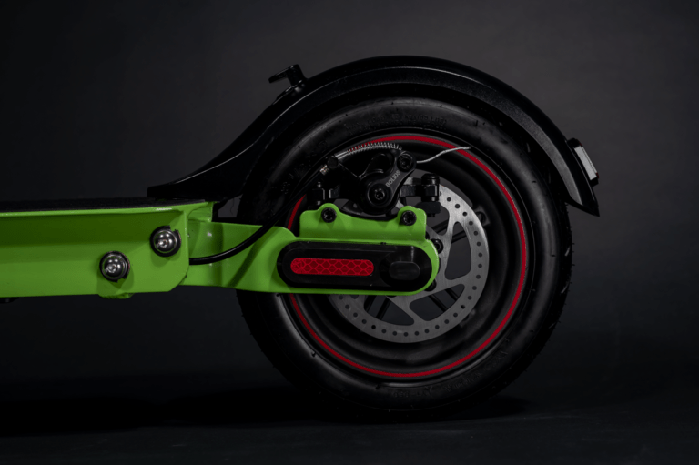 close up of electric scooter rear wheel, disc brake and caliper