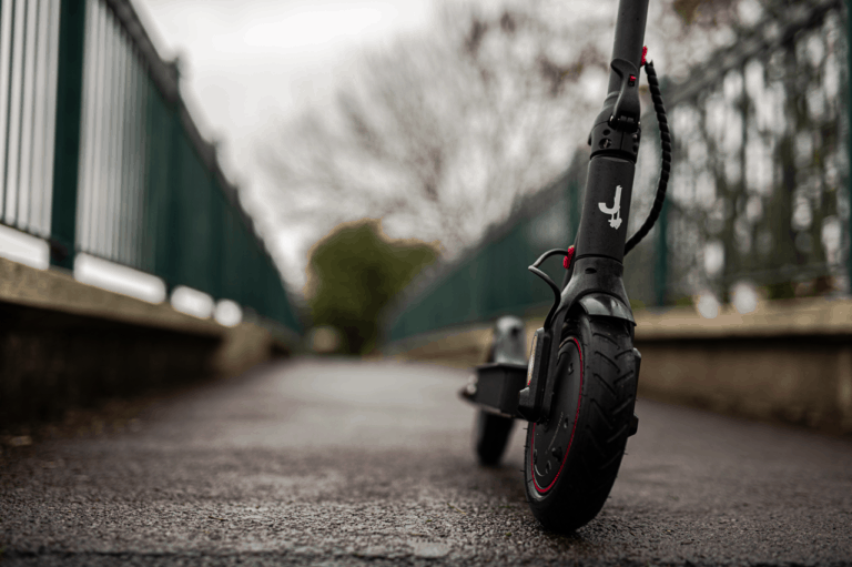black electric scooter jungle one on footpath